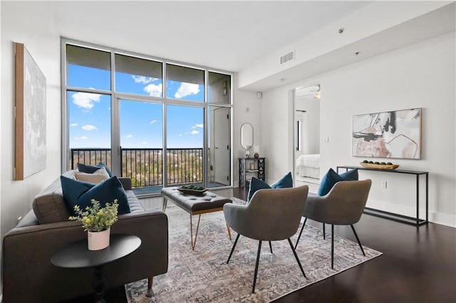 living room with hardwood / wood-style floors, expansive windows, and ceiling fan