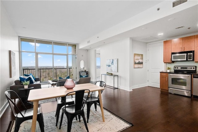 dining area with expansive windows and dark hardwood / wood-style floors