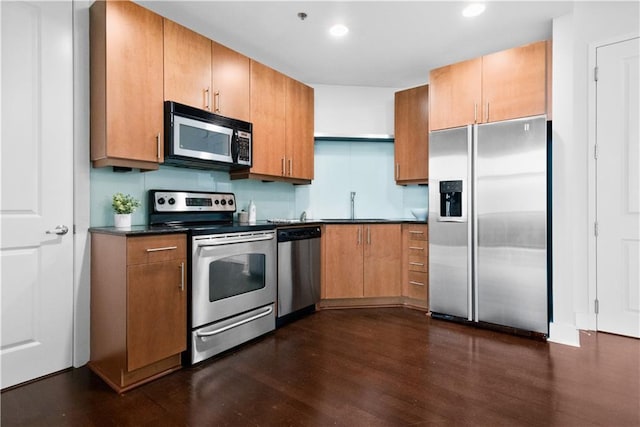 kitchen featuring dark hardwood / wood-style flooring, sink, and stainless steel appliances