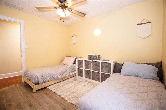 bedroom with hardwood / wood-style flooring and ceiling fan