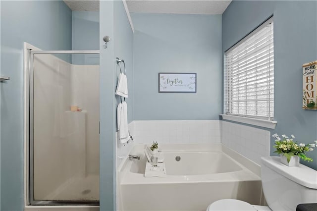 full bathroom with a textured ceiling, a garden tub, toilet, and a shower stall