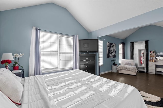 bedroom with lofted ceiling and wood finished floors