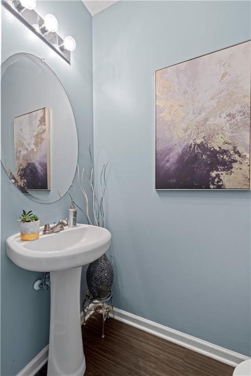 bathroom featuring baseboards and wood finished floors