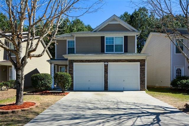 traditional home featuring a garage, stone siding, and driveway