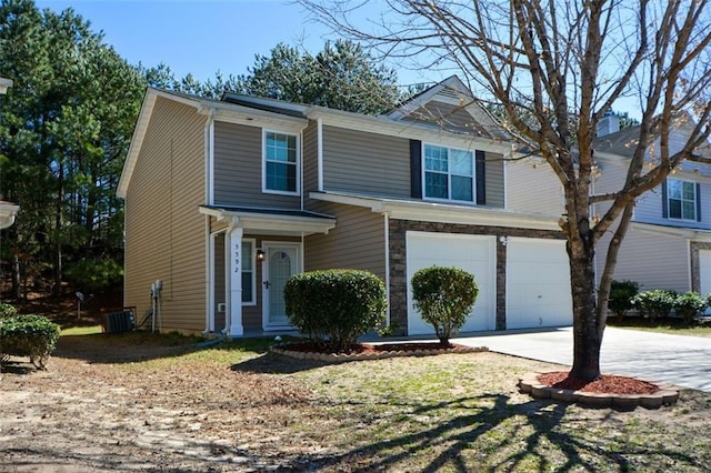 view of front of house with an attached garage, stone siding, and concrete driveway