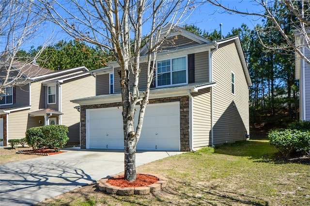 view of front of home with an attached garage, stone siding, concrete driveway, and a front yard