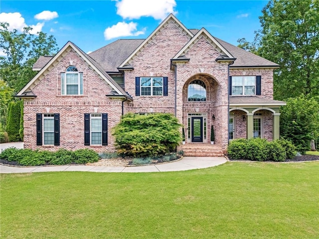 view of front of property with brick siding and a front lawn