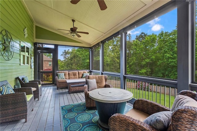 sunroom featuring a ceiling fan, lofted ceiling, and outdoor lounge area