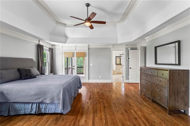 bedroom with a raised ceiling, dark wood finished floors, access to outside, crown molding, and a ceiling fan