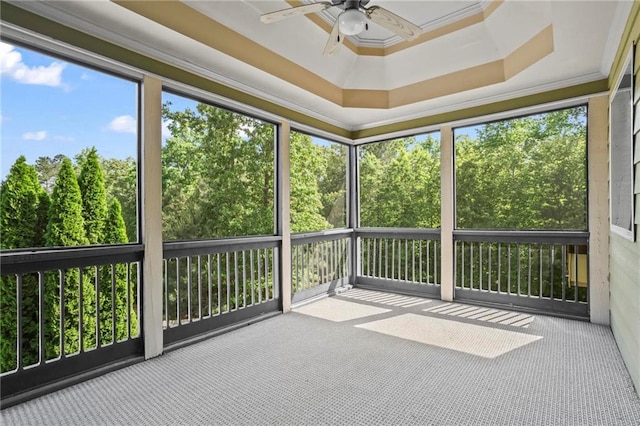 unfurnished sunroom featuring ceiling fan and healthy amount of natural light