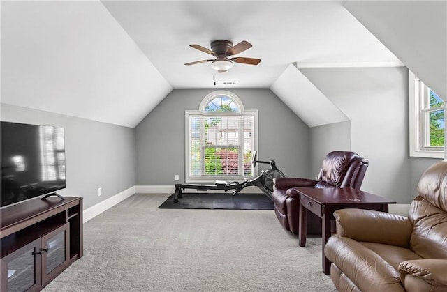 carpeted living area with baseboards, plenty of natural light, a ceiling fan, and lofted ceiling