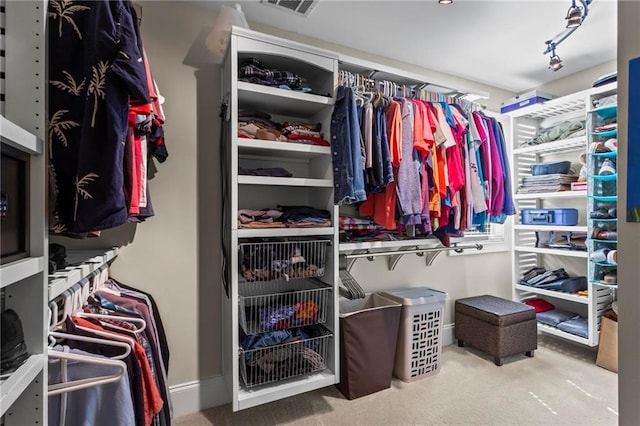 walk in closet featuring carpet flooring