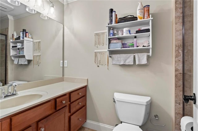 full bath featuring crown molding, toilet, a tile shower, and vanity