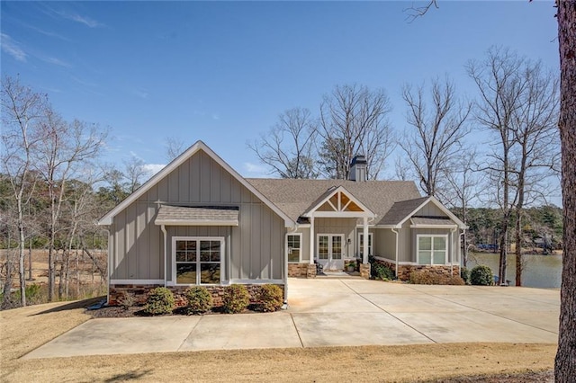 50 Quiet Cove Way, Monticello, GA 31064 - craftsman-style house with a chimney, a shingled roof, board and batten siding, stone siding, and french doors