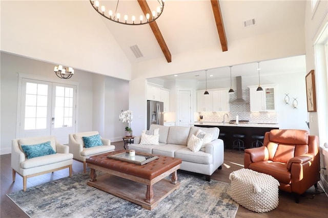 50 Quiet Cove Way, Monticello, GA 31064 - living room featuring a chandelier, high vaulted ceiling, wood finished floors, beam ceiling, and baseboards