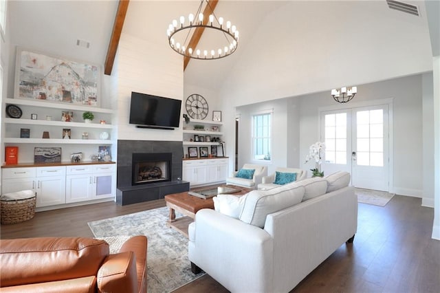 50 Quiet Cove Way, Monticello, GA 31064 - living room featuring a chandelier, high vaulted ceiling, a fireplace with raised hearth, wood finished floors, and beamed ceiling