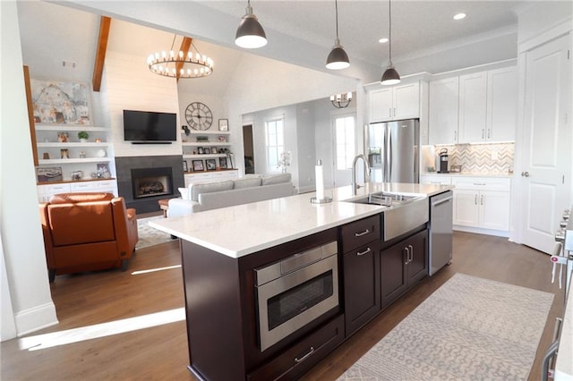 50 Quiet Cove Way, Monticello, GA 31064 - kitchen with appliances with stainless steel finishes, a chandelier, a sink, light countertops, and lofted ceiling