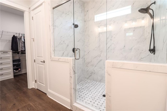 50 Quiet Cove Way, Monticello, GA 31064 - bathroom featuring a marble finish shower, wood finished floors, and a walk in closet
