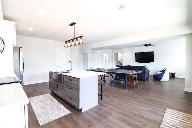 50 Quiet Cove Way, Monticello, GA 31064 - kitchen with a sink, light countertops, freestanding refrigerator, dark wood finished floors, and gray cabinets