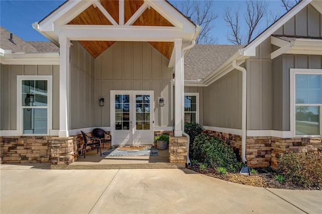 50 Quiet Cove Way, Monticello, GA 31064 - view of exterior entry featuring roof with shingles, board and batten siding, and stone siding