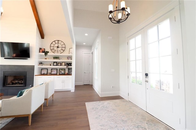 50 Quiet Cove Way, Monticello, GA 31064 - foyer entrance featuring a large fireplace, a chandelier, wood finished floors, plenty of natural light, and beam ceiling