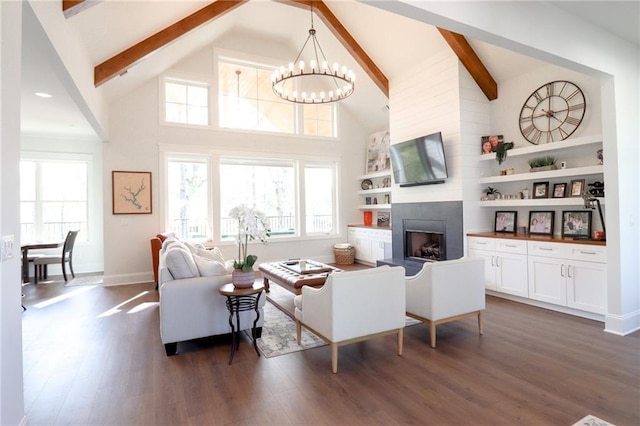 50 Quiet Cove Way, Monticello, GA 31064 - living room with a chandelier, beamed ceiling, dark wood-type flooring, a large fireplace, and high vaulted ceiling