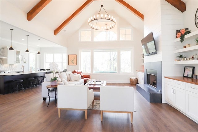 50 Quiet Cove Way, Monticello, GA 31064 - living area with a chandelier, high vaulted ceiling, beamed ceiling, dark wood-type flooring, and a fireplace