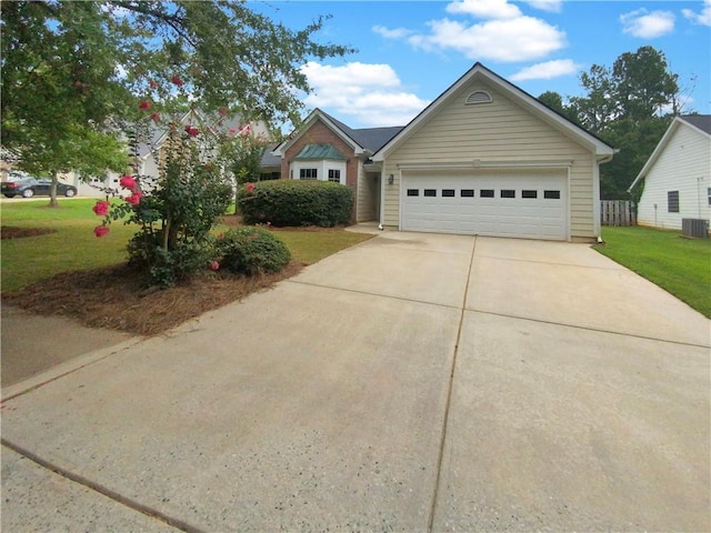 view of front of house with a garage and a front lawn