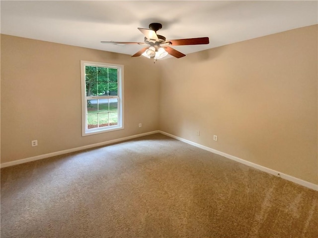 carpeted spare room with ceiling fan