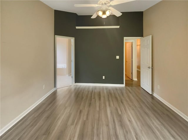 unfurnished room featuring ceiling fan, lofted ceiling, and light wood-type flooring