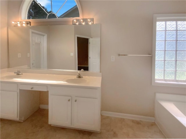 bathroom with vanity and a tub to relax in