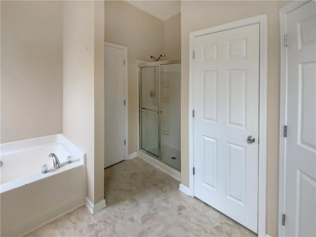 bathroom featuring tile patterned floors and separate shower and tub