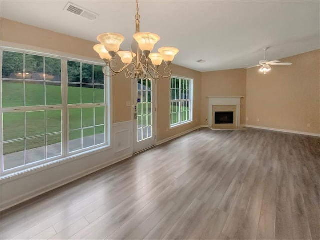 unfurnished living room with wood-type flooring and ceiling fan with notable chandelier