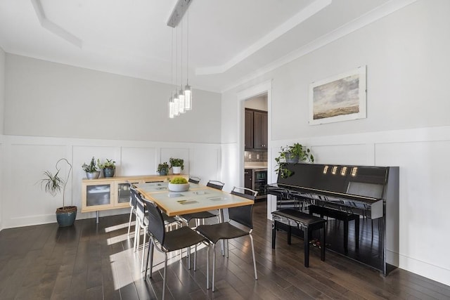 dining space with a raised ceiling and dark wood-type flooring