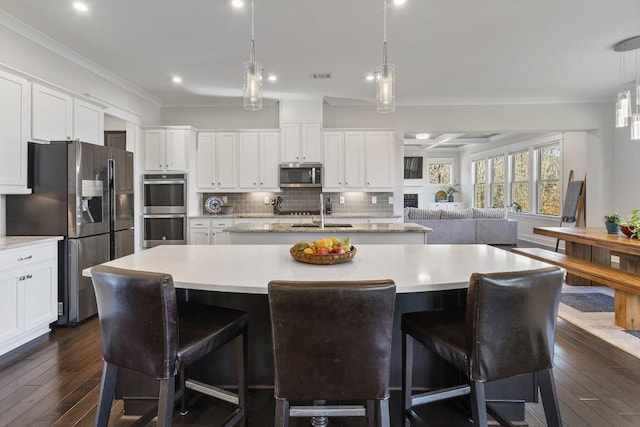 kitchen featuring a spacious island, hanging light fixtures, and appliances with stainless steel finishes