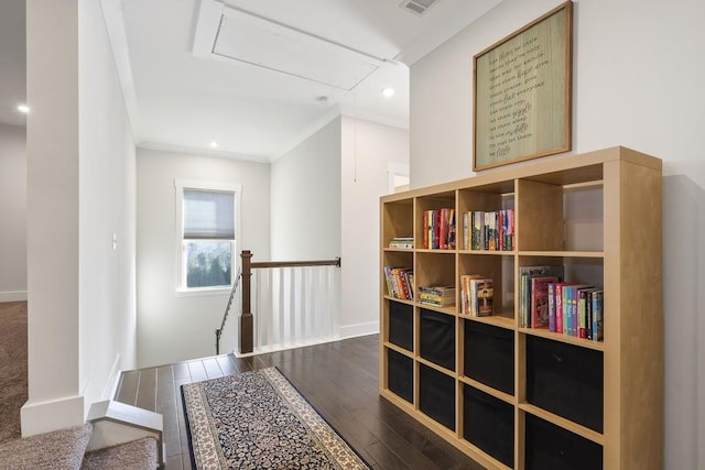 hall with dark hardwood / wood-style floors and ornamental molding