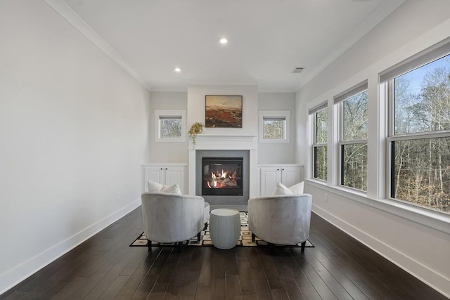 living area featuring crown molding and dark wood-type flooring