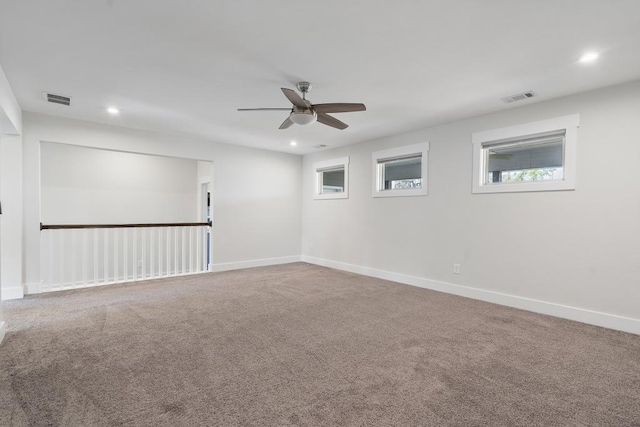 carpeted empty room featuring ceiling fan