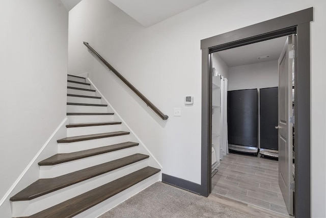 stairs with hardwood / wood-style flooring