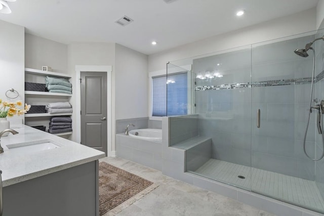 bathroom featuring tile patterned flooring, vanity, and independent shower and bath