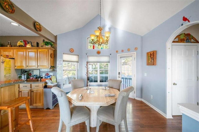 dining area with vaulted ceiling, dark wood-type flooring, and a notable chandelier