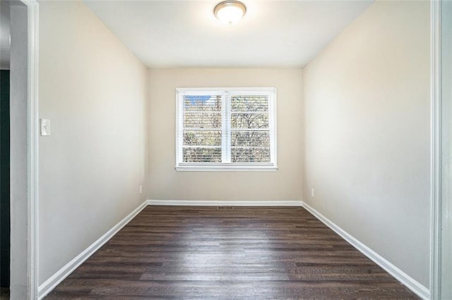 spare room featuring dark hardwood / wood-style floors