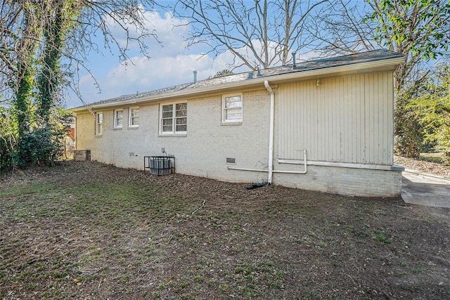 rear view of property featuring central AC