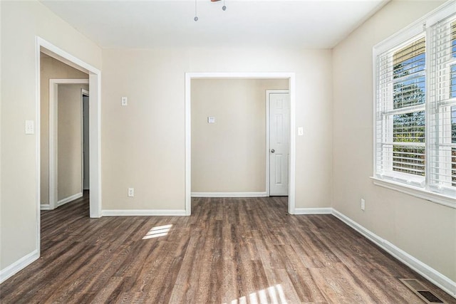 unfurnished room featuring dark hardwood / wood-style flooring