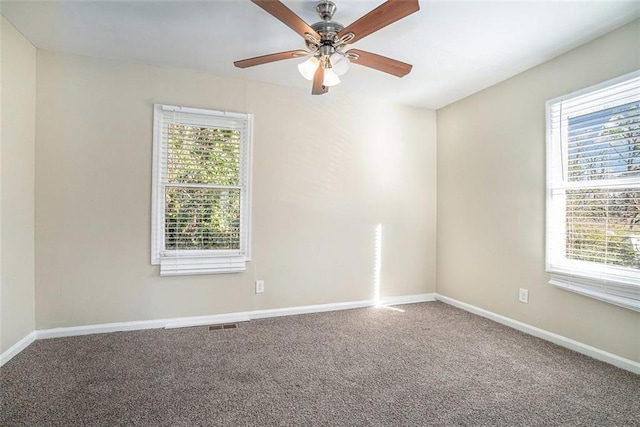 carpeted spare room with ceiling fan