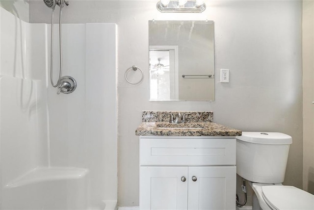 bathroom with vanity, toilet, and walk in shower