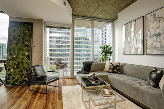 living room featuring hardwood / wood-style flooring and a wall of windows