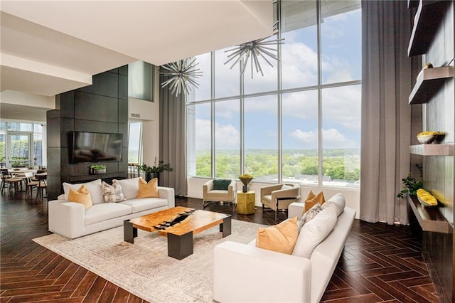 living room featuring dark parquet flooring and a high ceiling