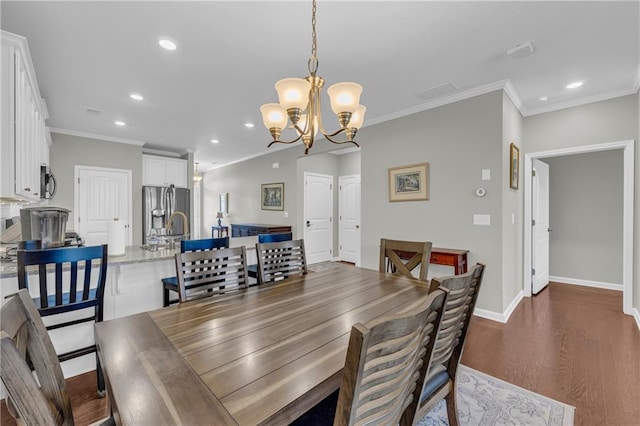 2735 Kimblewick Ct, Cumming, GA 30040 - dining room featuring baseboards, dark wood finished floors, crown molding, a notable chandelier, and recessed lighting