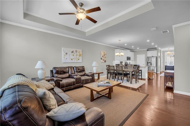 2735 Kimblewick Ct, Cumming, GA 30040 - living room with visible vents, dark wood finished floors, a raised ceiling, crown molding, and ceiling fan with notable chandelier